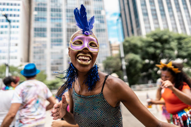 portrait of a young woman having fun at a street carnival party - laughing street party carnival beauty 뉴스 사진 이미지