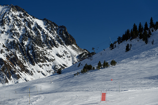 Snowy mountains, fir tree, ski slope under the snow. Winter sport