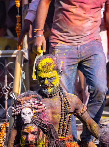 Varanasi, Uttar Pradesh, India - March 2023: Masan holi, Group of people celebrating the festival of holi at manikarnika ghat with colours.