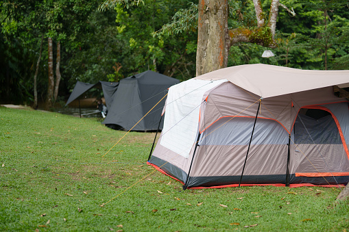 A group of tents is pitched in a camping ground, creating a picturesque scene that reflects the spirit of outdoor adventure and communal living.