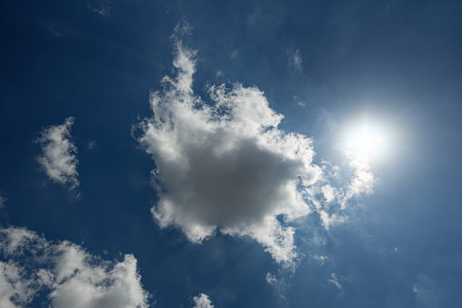 Dramatic afternoon cloudscape against a blue sky backdrop with orange sun lens flare Stellenbosch Cape Town South Africa