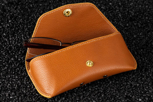 istock Glasses with leather case on a black background. 1977521943