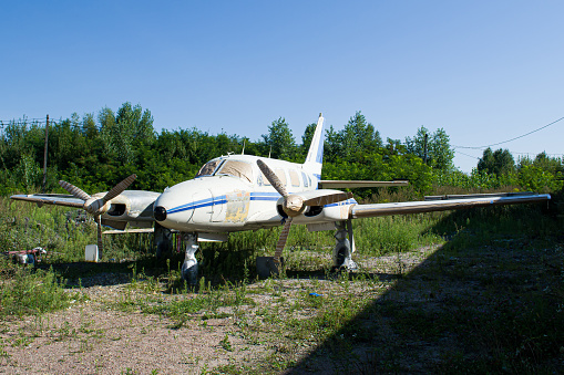 White small abandoned unbranded private passenger turboprop aircraft parked