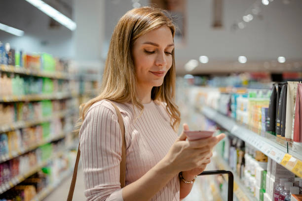 istock Female Choosing Product at Grocery Store 1977523620