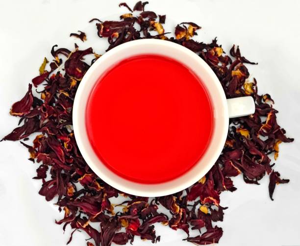 istock White cup of red tea with dry petals scattered around it 1977528182