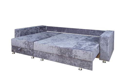 Gray unfolded sofa made of velor fabric isolated on a white background. Cushioned furniture.