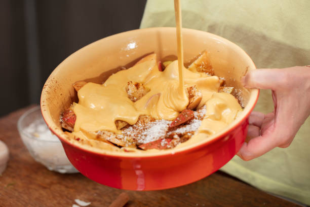 istock Pour the dough over the apples. Cooking apple pie. 1977531069