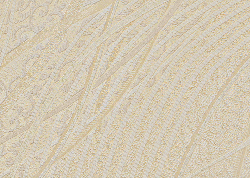 Background of beige paper wallpaper with textured swirled lines.