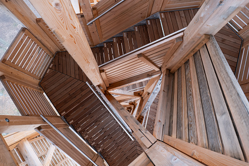 Spiraling wooden tower stairs. Top view, no people.