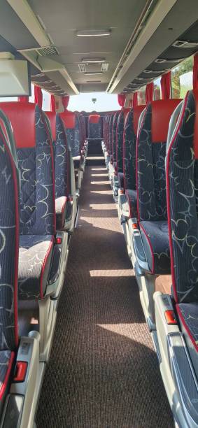 istock Empty bus interior seats. Inside a bus, empty seats in shuttle bus after passengers arrive at the destination after their road trip. 1977566827