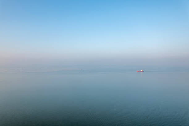 A bird's-eye view of a freight ship sailing at sea