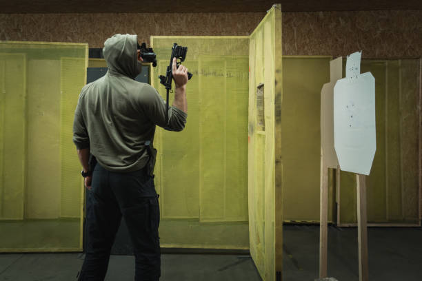 istock Tactical shooting from modern firearms with night vision at a shooting range, close-up photo. A man holds a carbine pistol in his hand. 1977606498