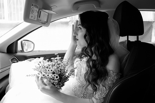 The Bride and groom holding hands. Hands are newlyweds with wedding rings. Rings and engagement. Bride and groom wearing embroidered dress and shirts hold hands together closeup. Black and white photo