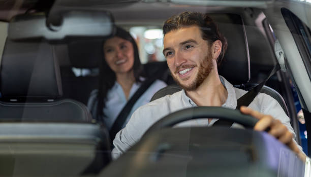 istock Happy crowdsourced taxi driver taking to a passenger 1977644896