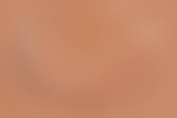 istock peach color trend 2024 color spot light, texture color gradient rough abstract background, shine bright light and glow template empty space grainy noise grungy 1977652219