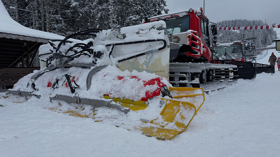 A snow plow machine for ski center, preparing the slope for skiing, snow cleaning machine,