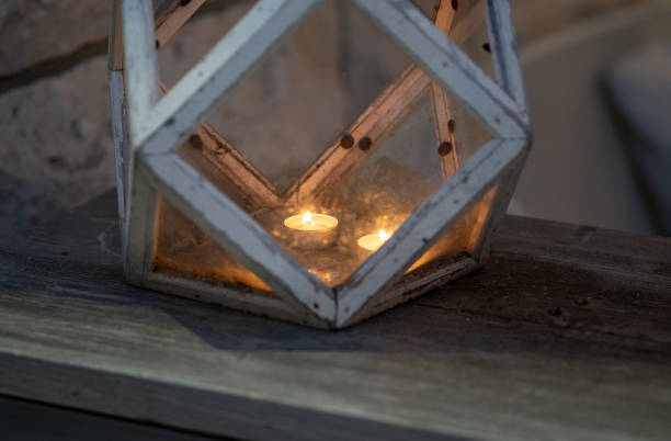 istock Burning candles against window at night 1977660210
