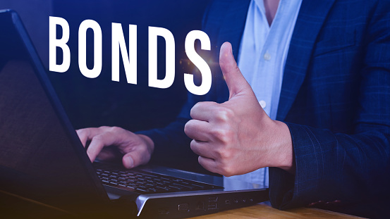 Businessman clicks bonds virtual screen. Bond Finance Banking Technology concept, Trade Market Network, bond security that indicates the investor has provided loan the issuer, Equivalent loan, Unsecured and secured bonds.