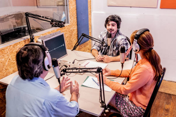 Presenters talking on a radio show