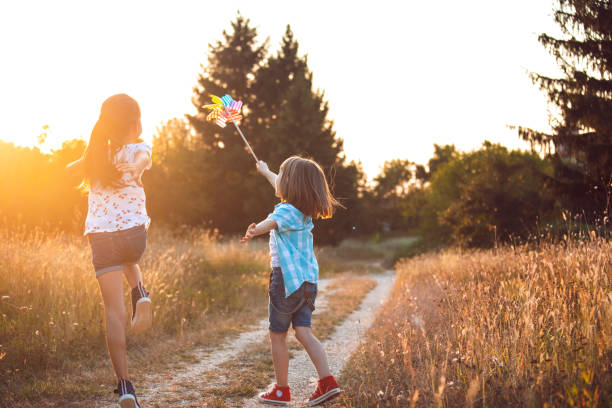 istock Happy children with pinwheel toy 1977680569