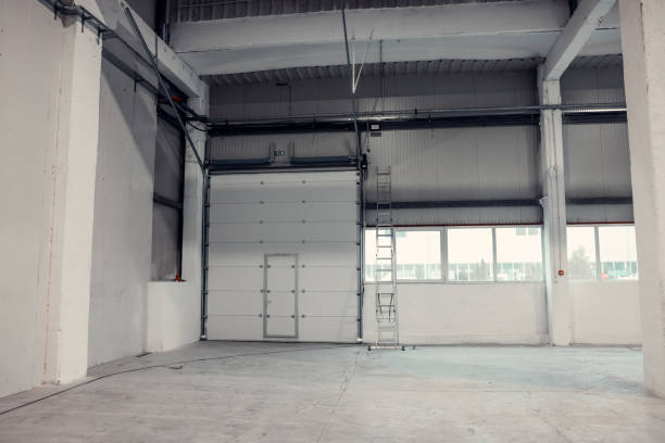 istock Roller door in a warehouse or factory. Industrial interior 1977686983