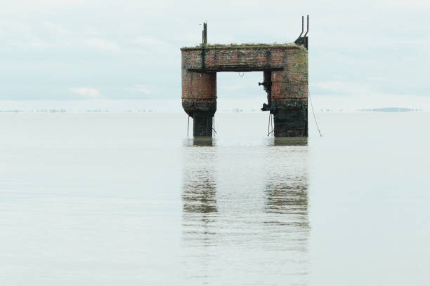 Decayed girder fragments of an old bridge construction in the sea