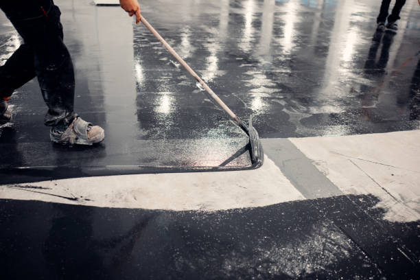 istock Worker applies gray epoxy reisin to a new floor. Modern Surface 1977718910