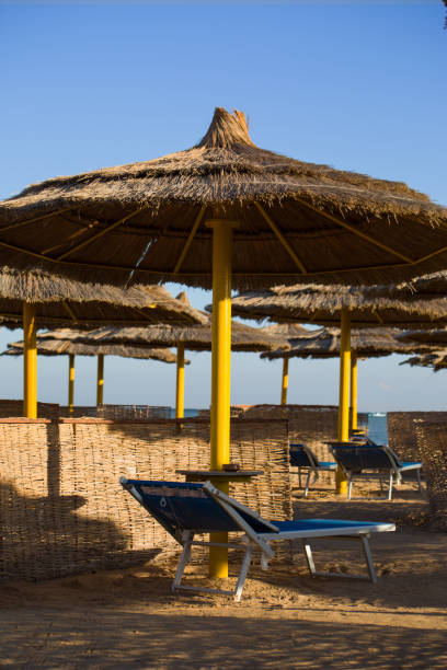 istock Straw round umbrella on the beach 1977743700