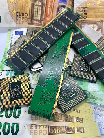 Close-up of microprocessors CPU RAM memory sticks on Euro banknotes 200EUR 50 EUR