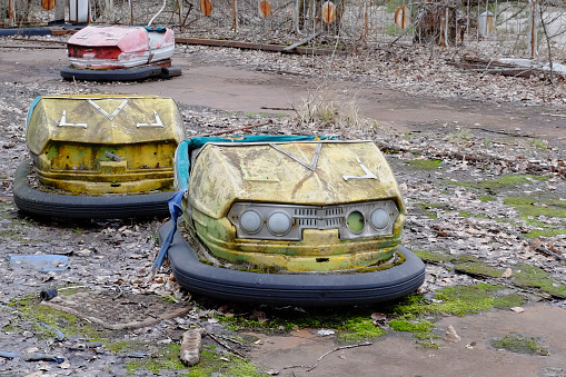 Cars in an abandoned amusement park in Pripyat. Rusty deserted attractions.