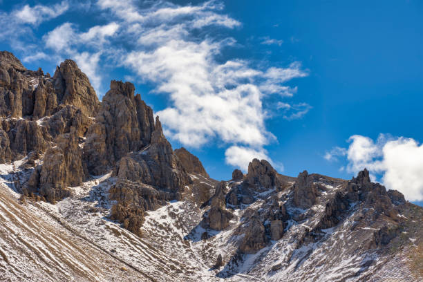 Peaks of Latemar mountain range in italian dolomites against blue sky. South Tyrol, Italy..