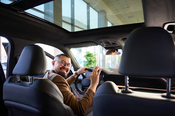 istock Young guy is happy with his new car 1977800695