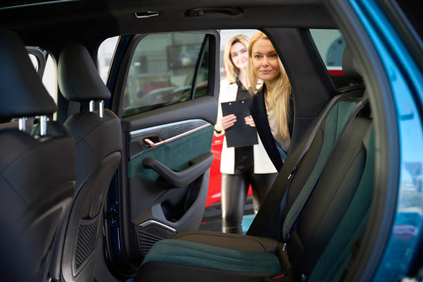 istock Lady shopper looks into the car interior 1977800714