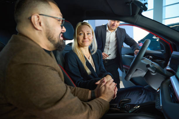 istock Smiling wife driving while looking at her husband 1977809093
