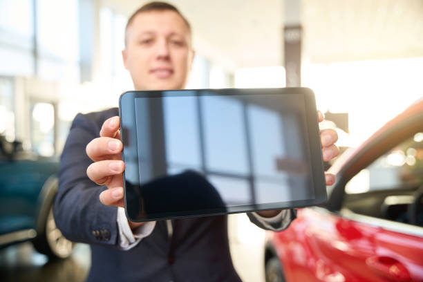 istock Seller shows his tablet to the camera 1977809613