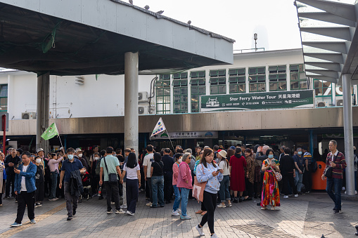 Hong Kong - December 5, 2023 : Tourists from the Chinese mainland at Tsim Sha Tsui in Kowloon, Hong Kong.