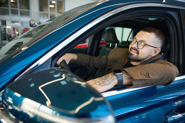 istock Man sits in a new blue car 1977812846