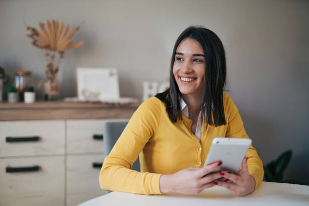 istock Beautiful young woman using her digital tablet 1977818837