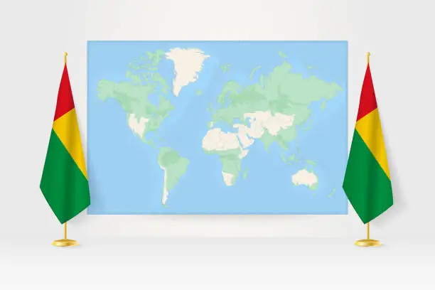 Vector illustration of World Map between two hanging flags of Guinea-Bissau flag stand.