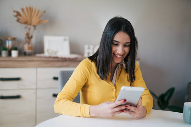 istock Beautiful young woman using her digital tablet 1977824735