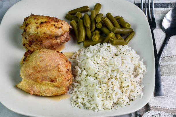 istock chicken thighs served with rice and  green beans, 1977828561