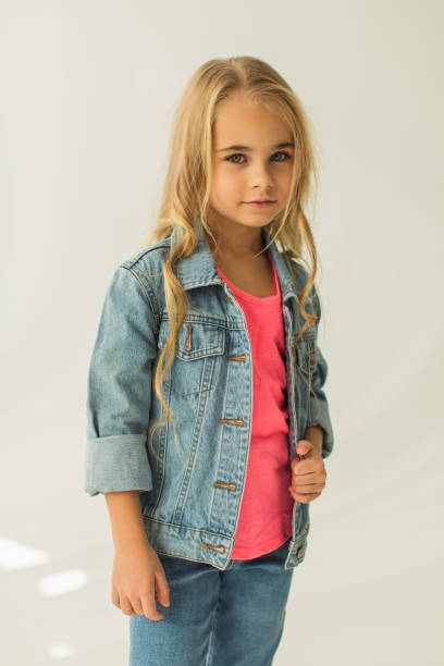 istock Blonde girl in denim suit in studio. Jeans 1977828578