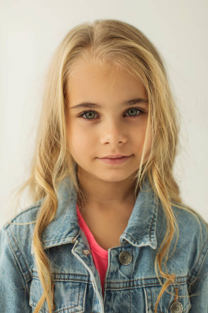 istock Blonde girl in denim suit in studio. Jeans 1977830240