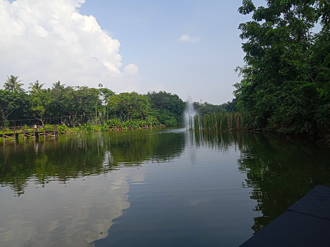 artificial lake with fountain in city park