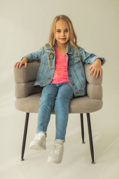 istock Blonde girl in denim suit in studio. Jeans 1977832407