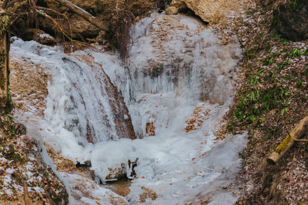 Ice formation and melting at a majestic mountain waterfall