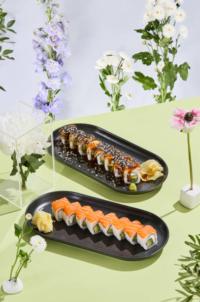 istock Philadelphia and Canada sushi rolls set against a surreal floral backdrop, evoking spring and summer vibes 1977846018