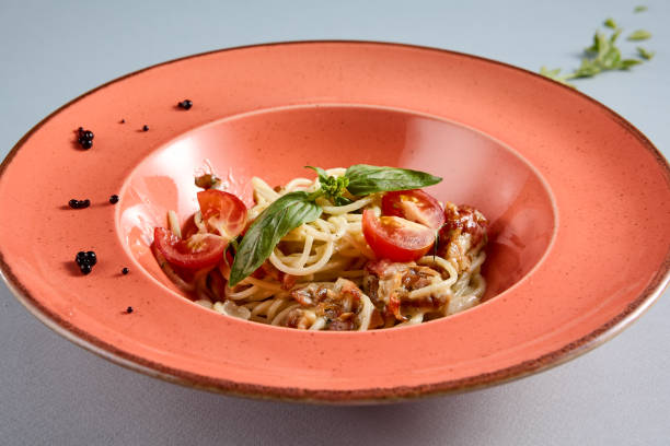 Delightful Carbonara pasta served in a terracotta dish, top view perfect for Italian cuisine recipes and food bloggers