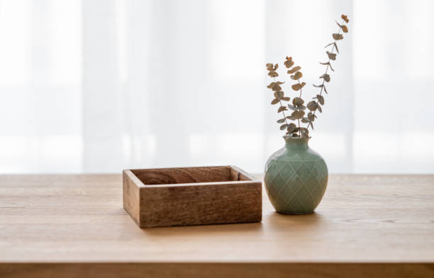 istock Wooden oak table top with a green vase with eucalyptus branches 1977903184