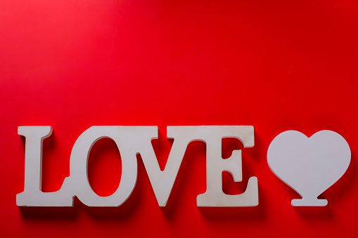 the inscription is love on a red background. Valentine's Day Greeting Card